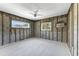 Unfinished bedroom features concrete floors, block walls and a ceiling fan at 1025 Boca Ciega Isle Dr, St Pete Beach, FL 33706