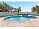 Beautiful backyard pool with tile and brick border, spa and lush palm trees at 1025 Boca Ciega Isle Dr, St Pete Beach, FL 33706