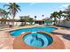 Inviting backyard oasis with a sparkling blue pool and mature landscaping at 1025 Boca Ciega Isle Dr, St Pete Beach, FL 33706
