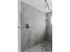 Newly renovated shower featuring gray tiling, pebble flooring and modern fixtures at 1025 Boca Ciega Isle Dr, St Pete Beach, FL 33706