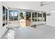 Bright sunroom with multiple windows overlooking the pool and patio area at 1025 Boca Ciega Isle Dr, St Pete Beach, FL 33706