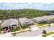 Aerial view of a beautiful neighborhood with well-maintained homes, lush landscaping and pond views at 10982 Banyan Breeze Blvd, Land O Lakes, FL 34638