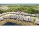 Beautiful community aerial view showcasing homes surrounding a tranquil lake with lush greenery at 10982 Banyan Breeze Blvd, Land O Lakes, FL 34638