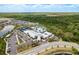 Stunning aerial view of the community center and pool area with lush landscaping and surrounding homes at 10982 Banyan Breeze Blvd, Land O Lakes, FL 34638