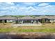 Backyard aerial showcasing a screened-in pool, a white fence, and a beautiful pond view at 10982 Banyan Breeze Blvd, Land O Lakes, FL 34638