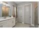 Bright bathroom showcasing a white vanity, glass-enclosed shower, and neutral tile flooring at 10982 Banyan Breeze Blvd, Land O Lakes, FL 34638