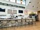 Cafe & Market featuring a bar with cafe menu board, television, and chairs in the community at 10982 Banyan Breeze Blvd, Land O Lakes, FL 34638