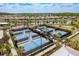 Community pickleball courts with lush landscaping and views of nearby homes and a lake at 10982 Banyan Breeze Blvd, Land O Lakes, FL 34638