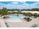 A relaxing zero-entry community pool surrounded by palm trees and comfortable lounge chairs at 10982 Banyan Breeze Blvd, Land O Lakes, FL 34638