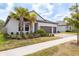 Beautiful single-story home boasts a tile roof, brick driveway, lush landscaping, and a two-car garage at 10982 Banyan Breeze Blvd, Land O Lakes, FL 34638