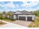 Beautiful single-Gathering home featuring a three-car garage, well manicured lawn and driveway at 10982 Banyan Breeze Blvd, Land O Lakes, FL 34638