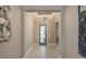 Inviting foyer featuring tile flooring, an elegant chandelier, and a decorative mirror at 10982 Banyan Breeze Blvd, Land O Lakes, FL 34638