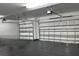 Spacious garage with insulated doors and dark epoxy flooring at 10982 Banyan Breeze Blvd, Land O Lakes, FL 34638