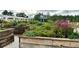 Community gardens featuring raised garden beds with a variety of flowers and vegetation in a tranquil setting at 10982 Banyan Breeze Blvd, Land O Lakes, FL 34638