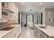 Well-designed kitchen with an island, seamlessly flowing into the dining area with natural light and modern decor at 10982 Banyan Breeze Blvd, Land O Lakes, FL 34638