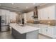 Bright kitchen with white cabinetry, stainless steel appliances, a tile backsplash, and a center island at 10982 Banyan Breeze Blvd, Land O Lakes, FL 34638