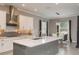 Open kitchen and dining area featuring a modern design with white cabinets and stainless steel appliances at 10982 Banyan Breeze Blvd, Land O Lakes, FL 34638