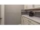 Modern kitchen with white cabinets, stainless steel appliances and gray countertops at 10982 Banyan Breeze Blvd, Land O Lakes, FL 34638