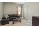 Cozy living room boasts a comfortable sectional sofa, soft carpet, and ample natural light at 10982 Banyan Breeze Blvd, Land O Lakes, FL 34638