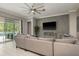 Elegant living room with tile flooring, custom wall details, and comfortable seating at 10982 Banyan Breeze Blvd, Land O Lakes, FL 34638
