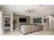 Spacious living room featuring stylish decor, a ceiling fan, and ample seating for entertaining at 10982 Banyan Breeze Blvd, Land O Lakes, FL 34638
