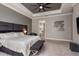 Comfortable main bedroom with ceiling fan and entry into bathroom, with tub and shower at 10982 Banyan Breeze Blvd, Land O Lakes, FL 34638