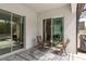 Cozy patio with stylish outdoor furniture, rug, and serene views through sliding glass doors at 10982 Banyan Breeze Blvd, Land O Lakes, FL 34638