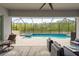 Relaxing screened patio area with a luxurious pool and spa, with comfortable seating at 10982 Banyan Breeze Blvd, Land O Lakes, FL 34638