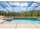 Screened-in pool and spa with beautiful tile work and serene view of natural preserve at 10982 Banyan Breeze Blvd, Land O Lakes, FL 34638