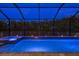 The screened-in pool and spa area offer a relaxing view of the lush greenery and natural landscape at 10982 Banyan Breeze Blvd, Land O Lakes, FL 34638