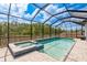 Stunning pool with spa, enclosed lanai, overlooking a lush landscape at 10982 Banyan Breeze Blvd, Land O Lakes, FL 34638