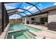 Gorgeous screened-in pool and spa with outdoor seating perfect for relaxing and entertaining at 10982 Banyan Breeze Blvd, Land O Lakes, FL 34638