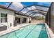 Gorgeous screened-in pool with outdoor seating perfect for relaxing and entertaining in the lanai at 10982 Banyan Breeze Blvd, Land O Lakes, FL 34638