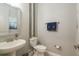 Charming powder room with pedestal sink, decorative mirror, and modern fixtures at 10982 Banyan Breeze Blvd, Land O Lakes, FL 34638