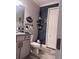 Charming bathroom featuring decorative wall with a gray vanity and rustic accessories at 11219 Paddock Manor Ave, Riverview, FL 33569