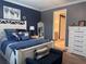 Beautiful bedroom features a blue accent wall, wood-look floors and a king-sized bed at 11219 Paddock Manor Ave, Riverview, FL 33569