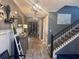 Inviting foyer with wood-look tile flooring, decorative ladder, and staircase with dark wood railing at 11219 Paddock Manor Ave, Riverview, FL 33569