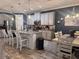 Modern kitchen with gray cabinets, granite countertops, stainless steel appliances, and an adjacent dining area at 11219 Paddock Manor Ave, Riverview, FL 33569