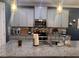 Close-up of the kitchen's granite countertop and stainless steel appliances with a mosaic backsplash at 11219 Paddock Manor Ave, Riverview, FL 33569