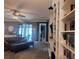 Spacious living room featuring built-in bookshelves, a gray sectional sofa, and backyard access at 11219 Paddock Manor Ave, Riverview, FL 33569