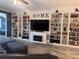 Cozy living room with a fireplace, built-in bookshelves, and a large screen television at 11219 Paddock Manor Ave, Riverview, FL 33569