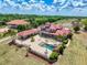Aerial view of a luxurious property with a pool, patio, and well-manicured lawn at 11715 Taylor Rd, Thonotosassa, FL 33592
