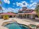 Expansive backyard featuring a pool, spa, and well-manicured landscaping with a grand residence at 11715 Taylor Rd, Thonotosassa, FL 33592