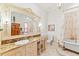 Bright bathroom with a vanity and makeup area, decorative mirror and classic clawfoot tub at 11715 Taylor Rd, Thonotosassa, FL 33592