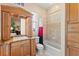 Bathroom with neutral tile, wood cabinets, granite countertops, and a shower-tub combination at 11715 Taylor Rd, Thonotosassa, FL 33592