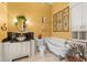 Charming bathroom with a clawfoot tub, decorative wall art, and unique glass bowl sink at 11715 Taylor Rd, Thonotosassa, FL 33592