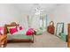 Bright bedroom with wooden furniture set, connected to a seating nook with playful polka dot curtains at 11715 Taylor Rd, Thonotosassa, FL 33592