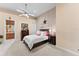 Comfortable bedroom with a ceiling fan, carpeted floors, and adjacent bathroom at 11715 Taylor Rd, Thonotosassa, FL 33592