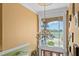Bright foyer with a large chandelier and a beautiful view of the landscaped grounds through a large window at 11715 Taylor Rd, Thonotosassa, FL 33592