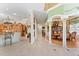Open hallway with decorative columns connecting to the dining area, kitchen, and front entrance at 11715 Taylor Rd, Thonotosassa, FL 33592
